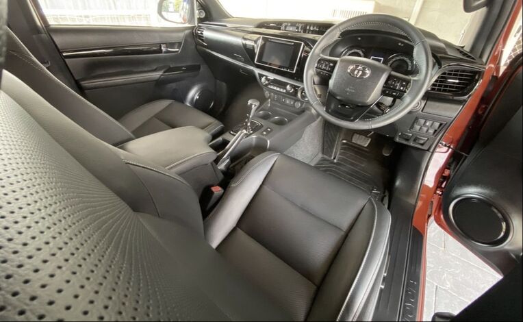 Photo taken from the open driver's door of a clean, detailed car seat and dashboard. Car Detailing North Brisbane.